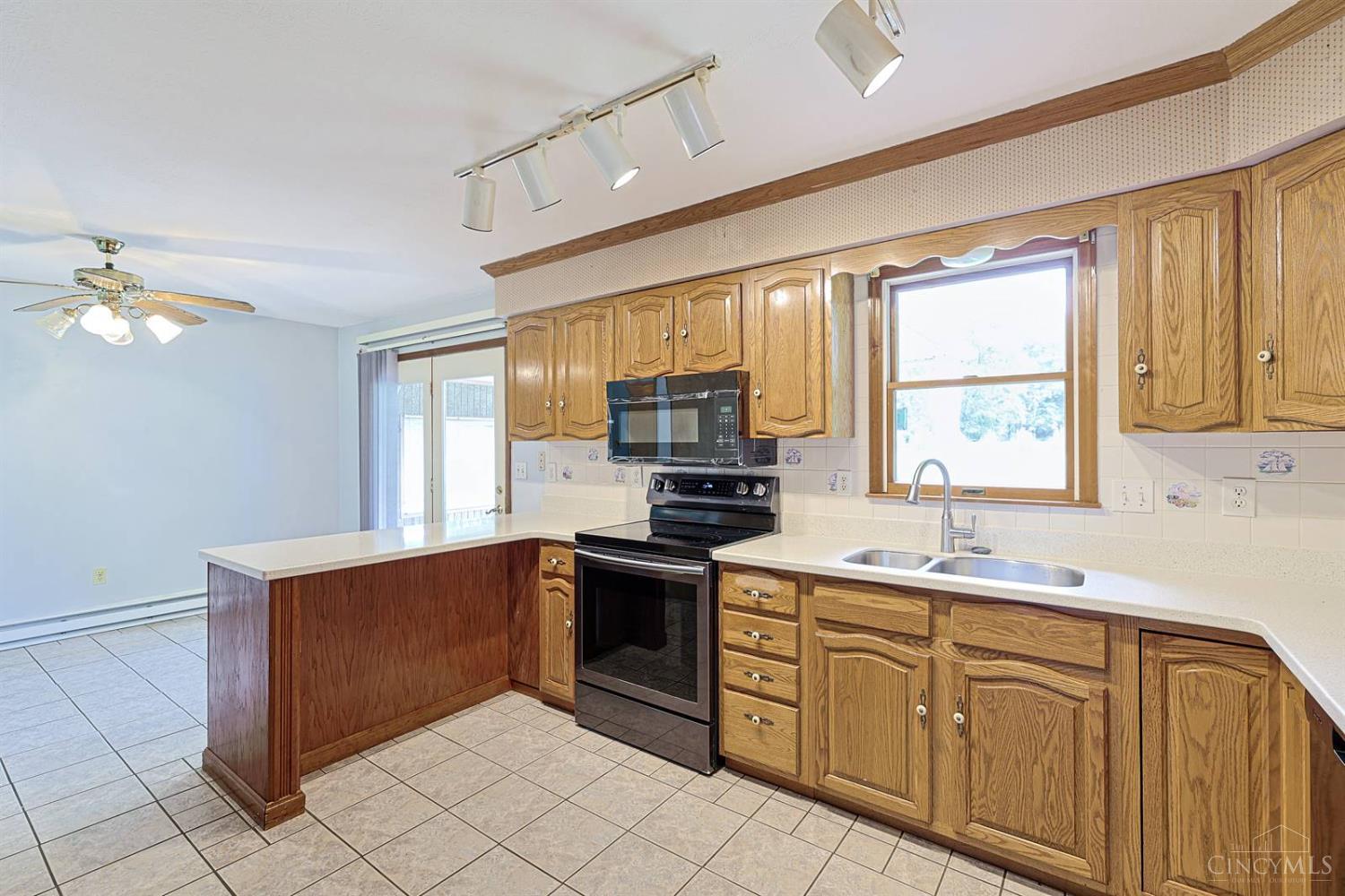 4617 Graybill Road Georgetown, OH 45121 - Photo 19 of 58 Large Kitchen With Solid Wood Cabinets Offers A Lot Of Storage Space. Breakfast Bar Area Allows For Seating On Both Sides. Walk Out To Your Stunning, Covered Back Porch With Beautiful Views.