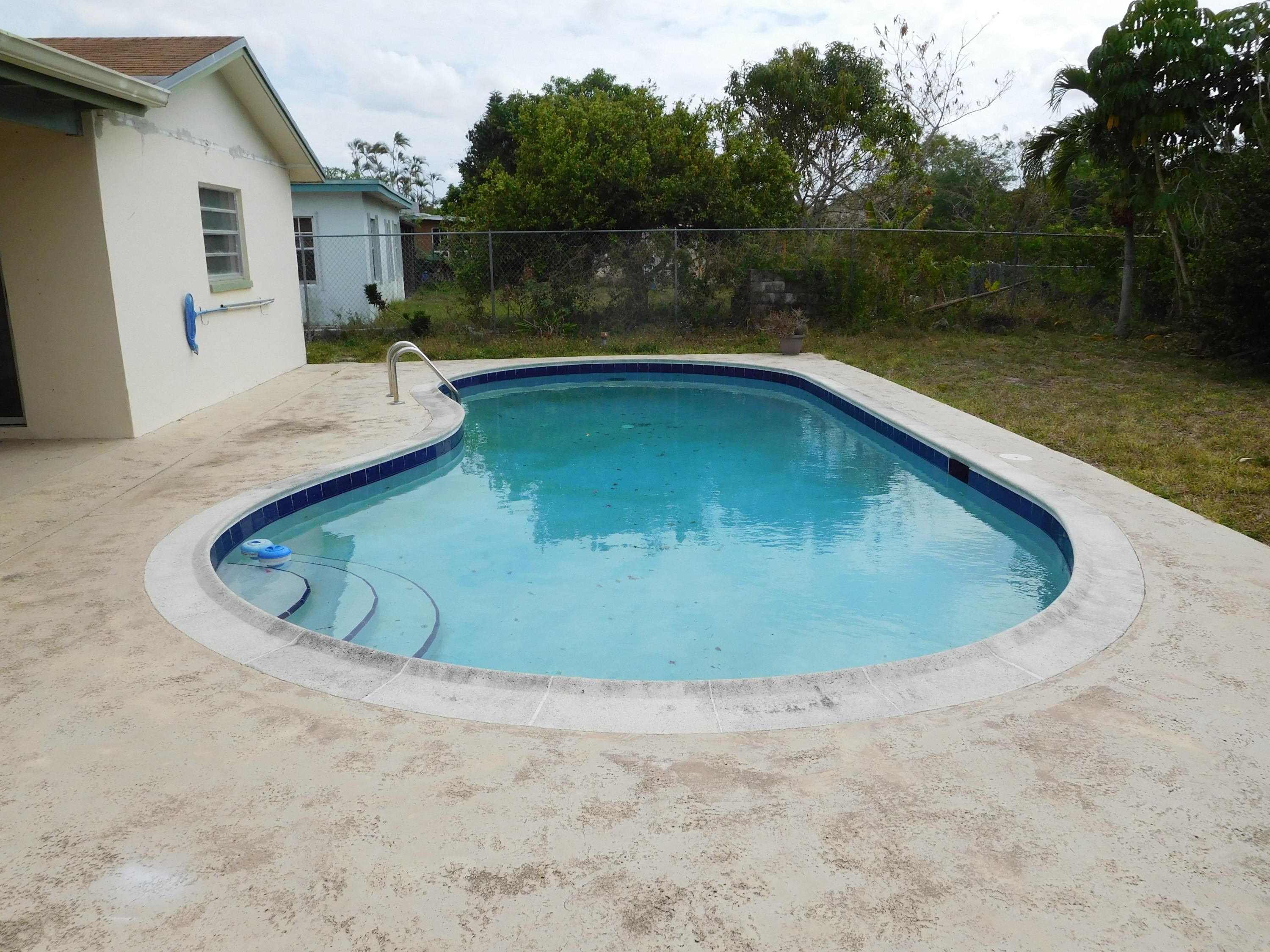 22367 Southwest 65th Avenue Boca Raton, FL 33428 - Photo 11 of 13 a view of a swimming pool with a yard from in back