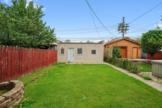 a view of an house with backyard and a flat screen tv