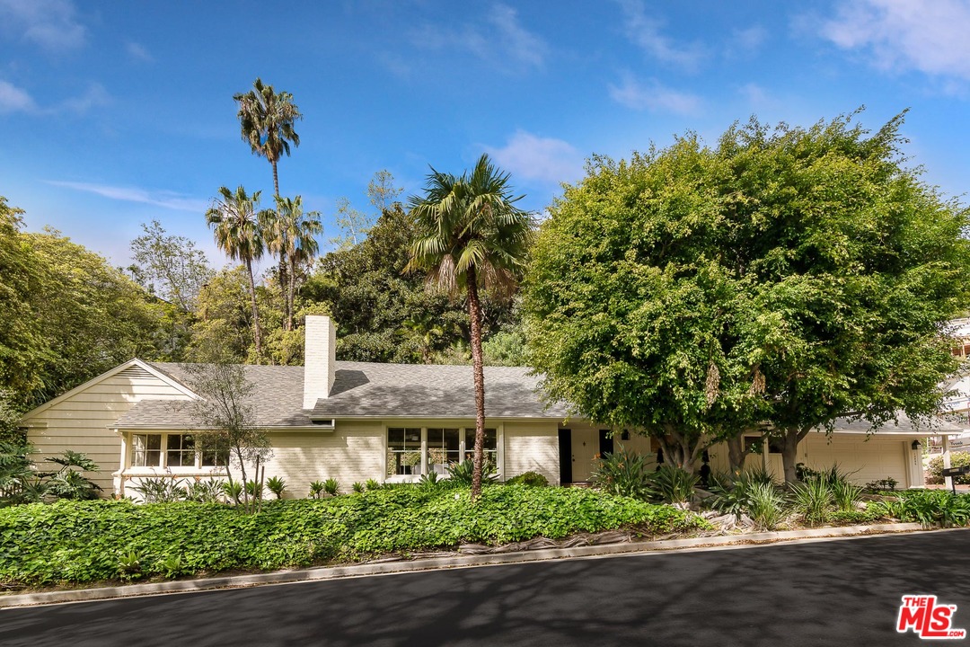 10886 Chalon Road Los Angeles, CA 90077 - Photo 1 of 33 a front view of a house with a yard