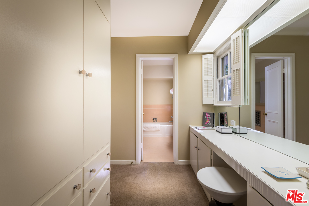 10886 Chalon Road Los Angeles, CA 90077 - Photo 16 of 33 a bathroom with a sink a toilet and a mirror