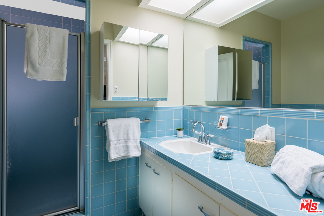 10886 Chalon Road Los Angeles, CA 90077 - Photo 23 of 33 a bathroom with a sink and a mirror
