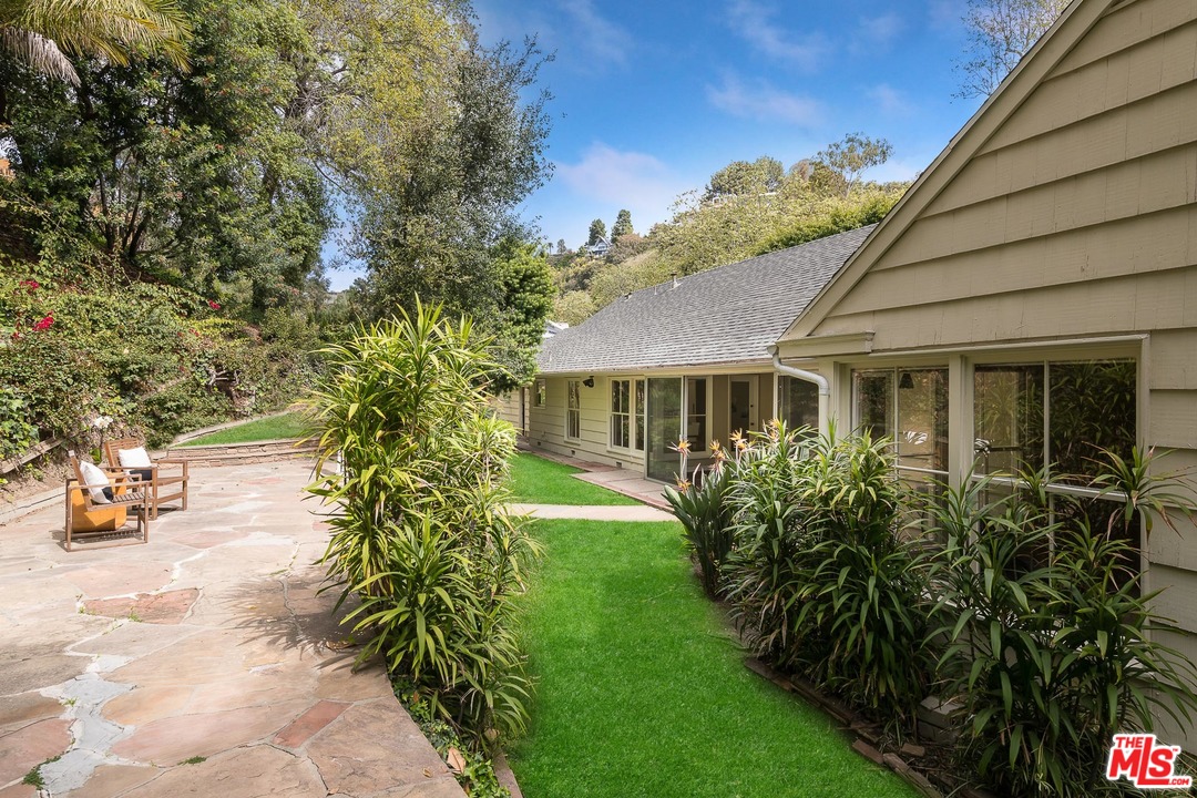 10886 Chalon Road Los Angeles, CA 90077 - Photo 29 of 33 a front view of a house with garden