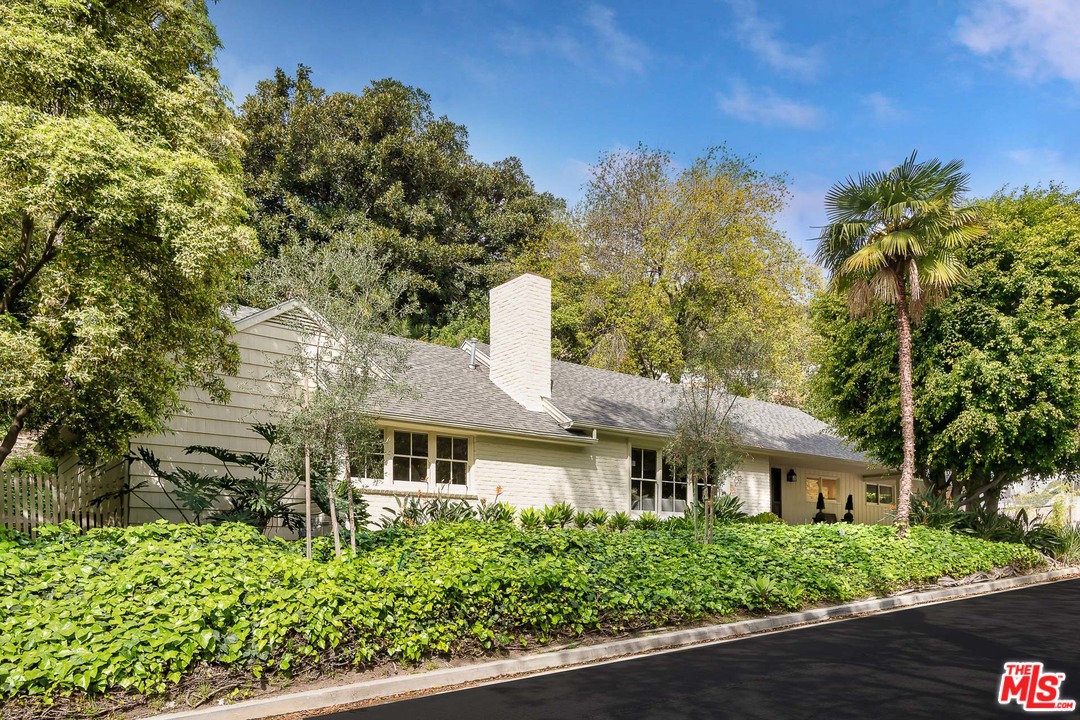 10886 Chalon Road Los Angeles, CA 90077 - Photo 33 of 33 front view of a house with a garden