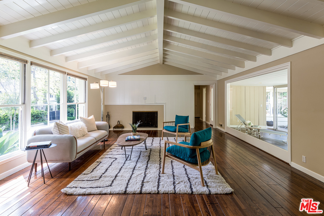 10886 Chalon Road Los Angeles, CA 90077 - Photo 7 of 33 a living room with furniture and a wooden floor