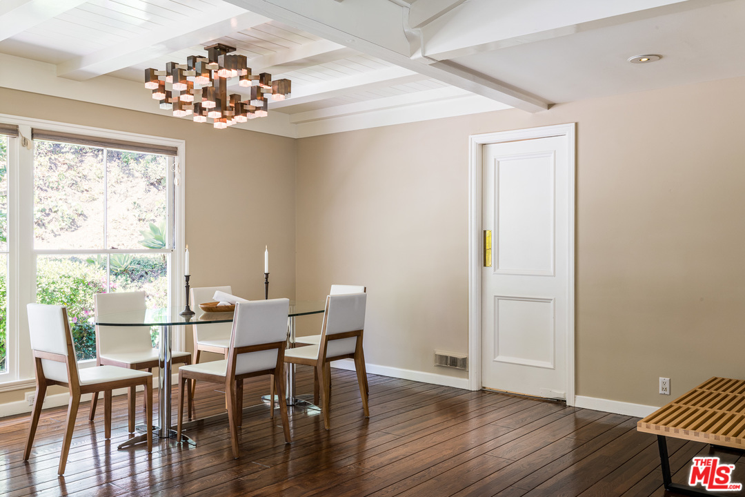 10886 Chalon Road Los Angeles, CA 90077 - Photo 9 of 33 a view of a dining room with furniture and wooden floor