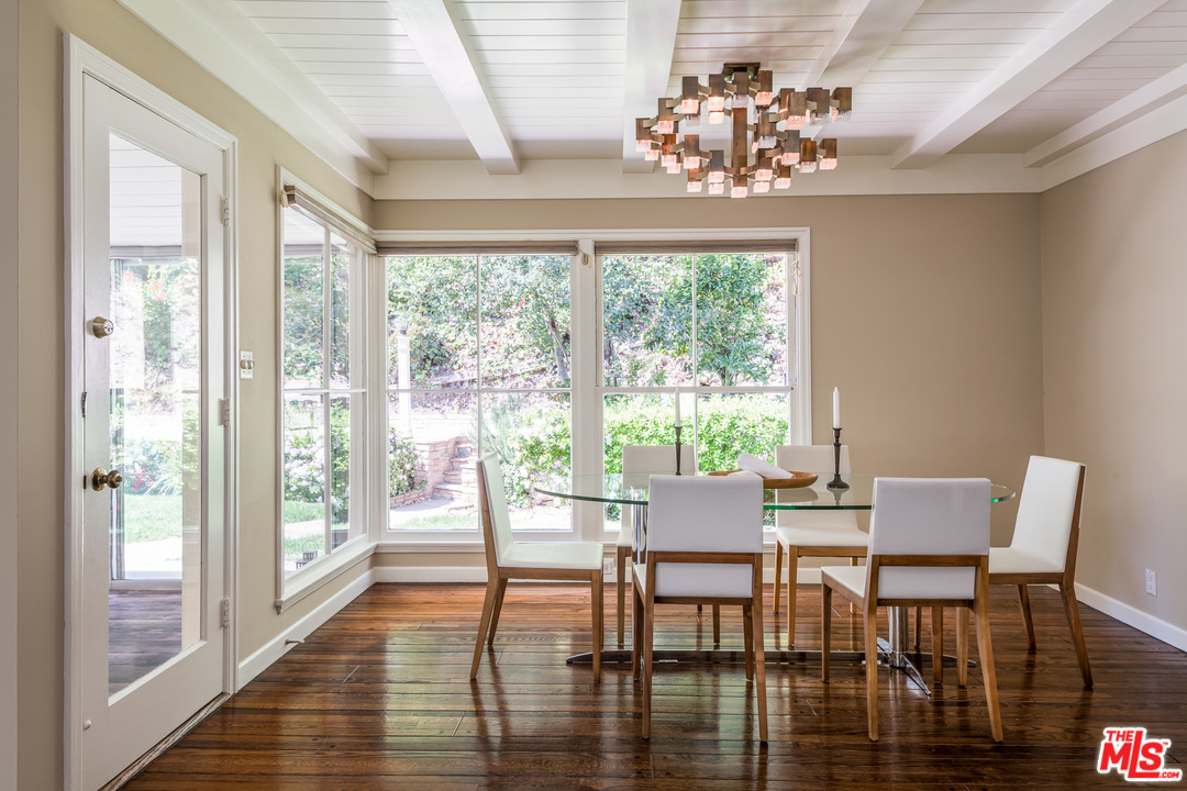 10886 Chalon Road Los Angeles, CA 90077 - Photo 10 of 33 a view of a dining room with furniture a chandelier and wooden floor