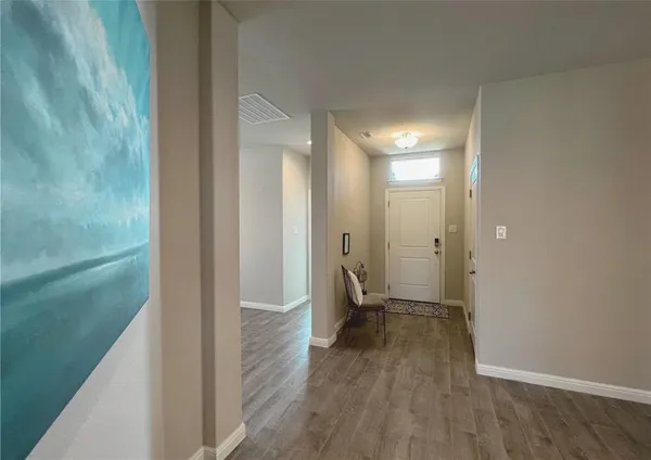 a view of a room with wooden floor