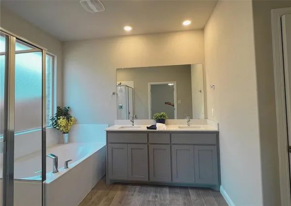 a bathroom with a double vanity sink and mirror