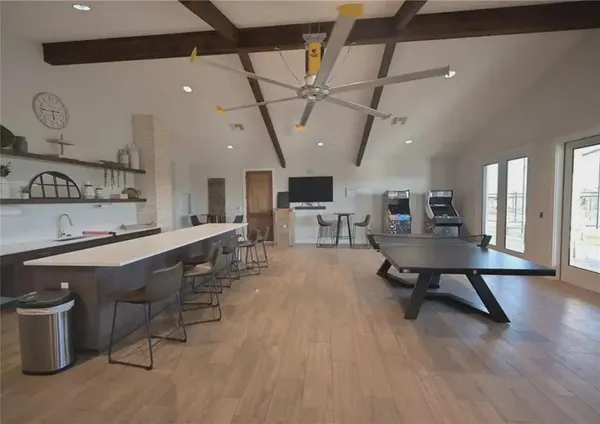 a room with lots of furniture and a wooden floor