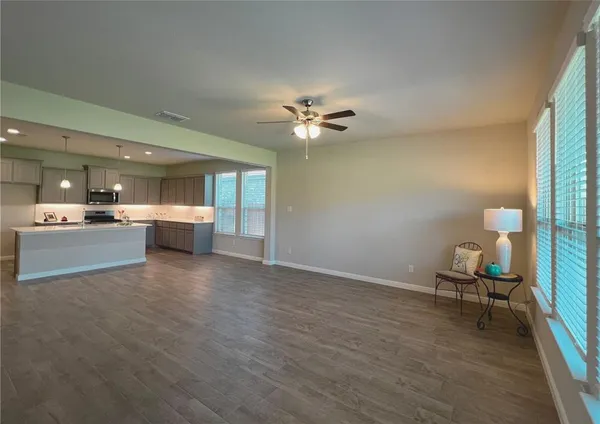 a view of a livingroom with a kitchen and a stove