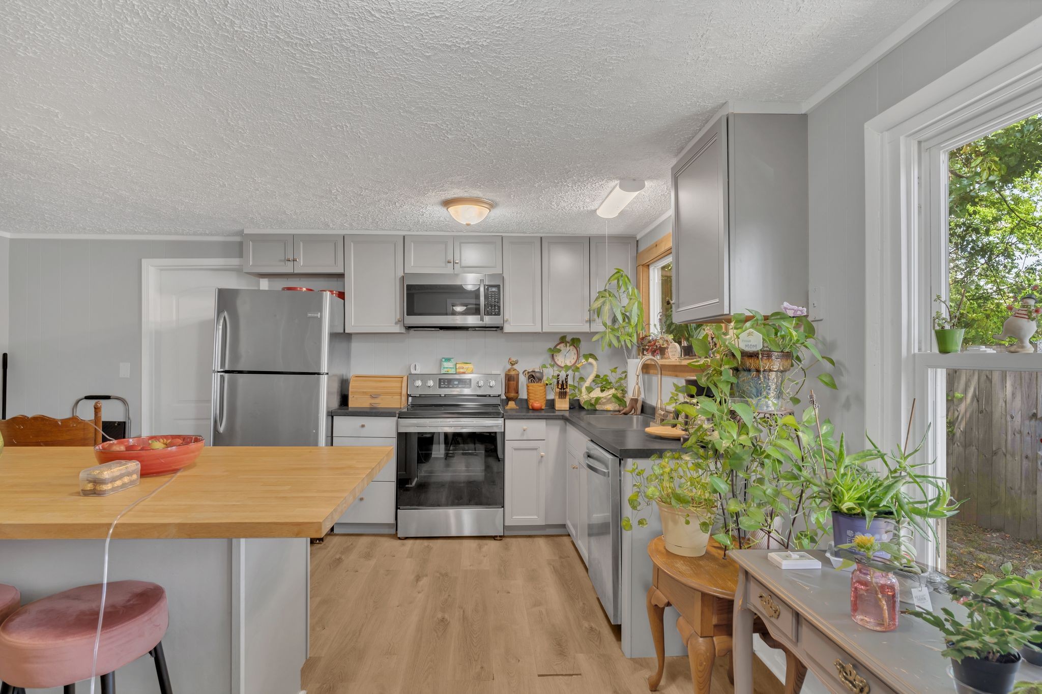 514 East 8th Avenue Springfield, TN 37172 - Photo 13 of 29 a kitchen with stainless steel appliances kitchen island granite countertop a refrigerator a stove a sink dishwasher and white cabinets with wooden floor
