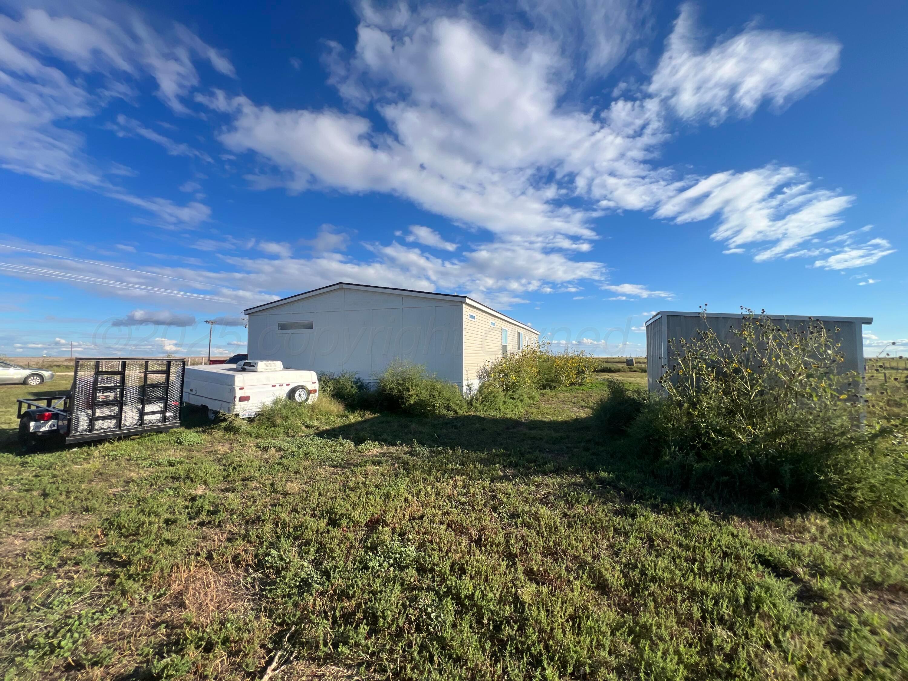 8269 County Road North Pampa, TX 79065 - Photo 18 of 21 a view of a house with a yard and sitting area
