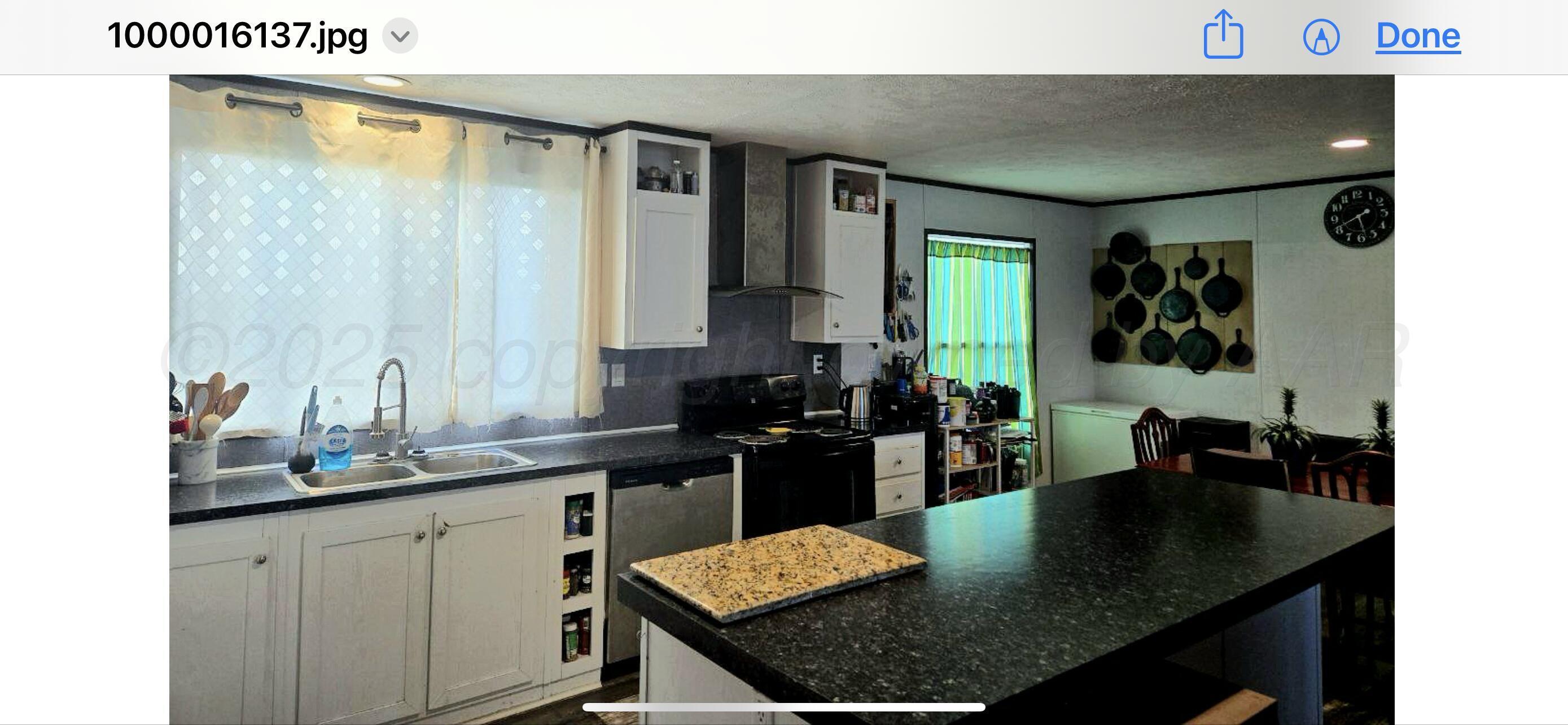 8269 County Road North Pampa, TX 79065 - Photo 2 of 21 a kitchen with a table chairs sink and cabinets