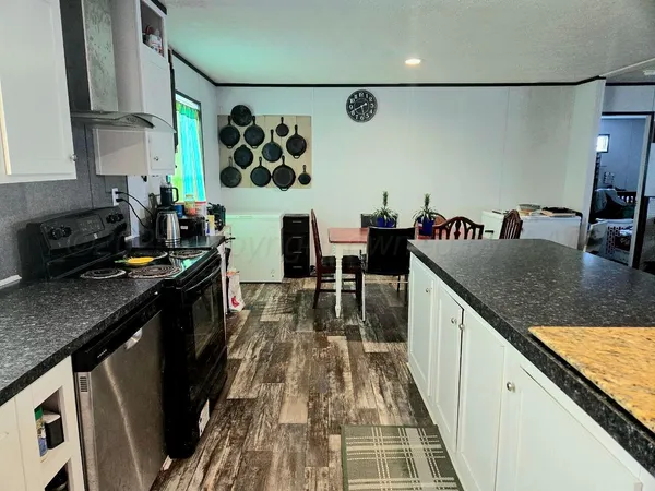 a kitchen with granite countertop lots of counter top space and stainless steel appliances