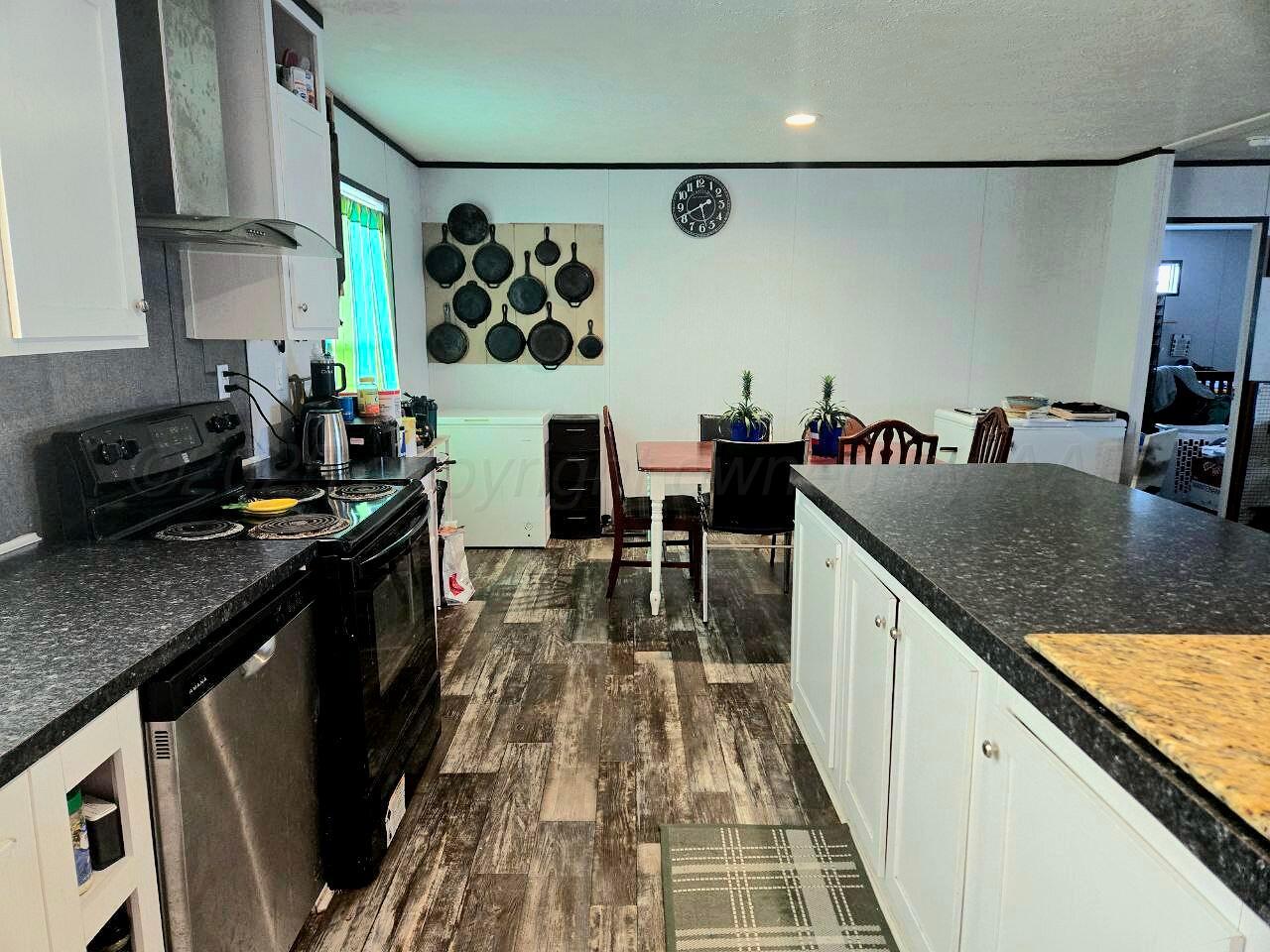 8269 County Road North Pampa, TX 79065 - Photo 3 of 21 a kitchen with granite countertop lots of counter top space and stainless steel appliances