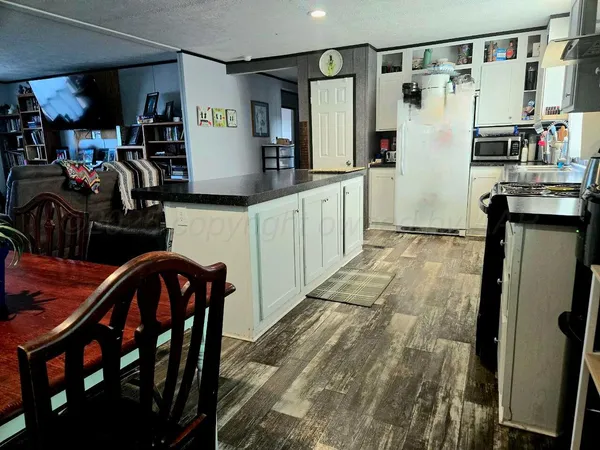 a kitchen with stainless steel appliances granite countertop a refrigerator and microwave