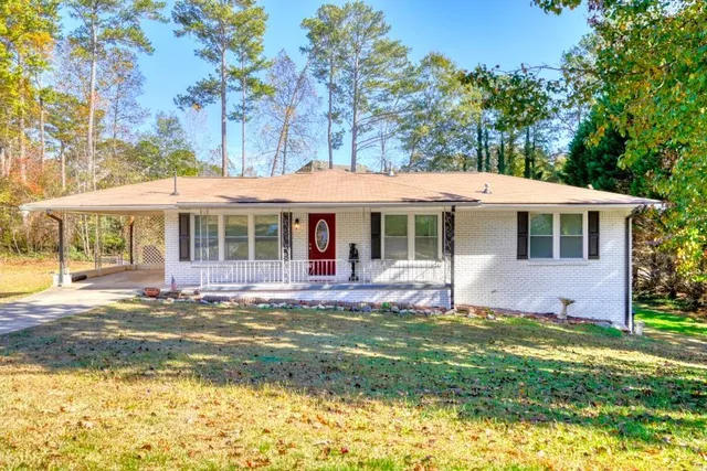 a front view of a house with a yard table and chairs