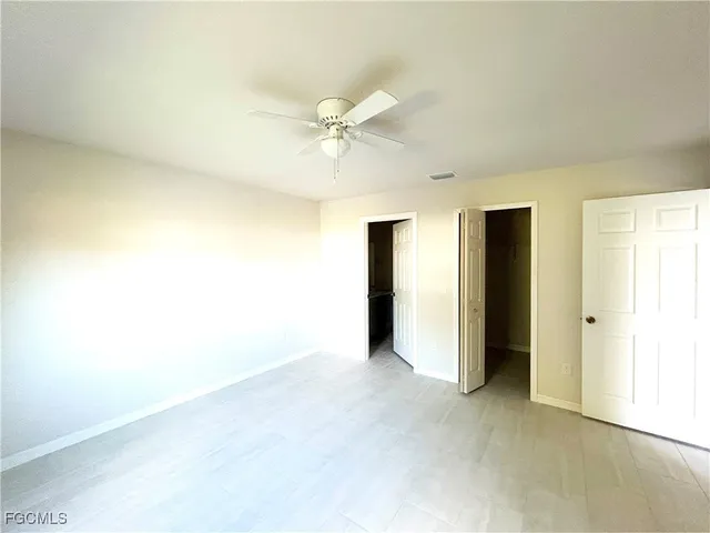 a view of an empty room with a ceiling fan