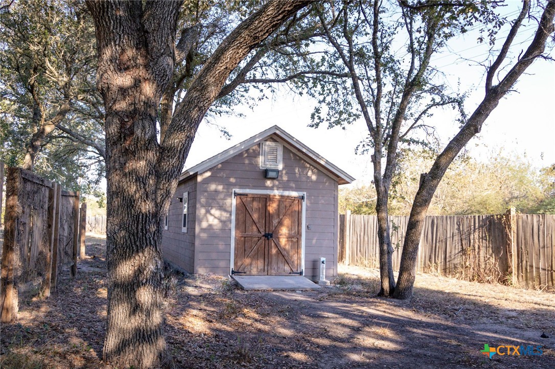 447 Schaefer Road Victoria, TX 77905 - Photo 25 of 25 a view of a house with large trees and a barn