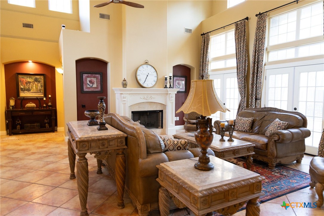 447 Schaefer Road Victoria, TX 77905 - Photo 7 of 25 a living room with furniture a fireplace and a large window