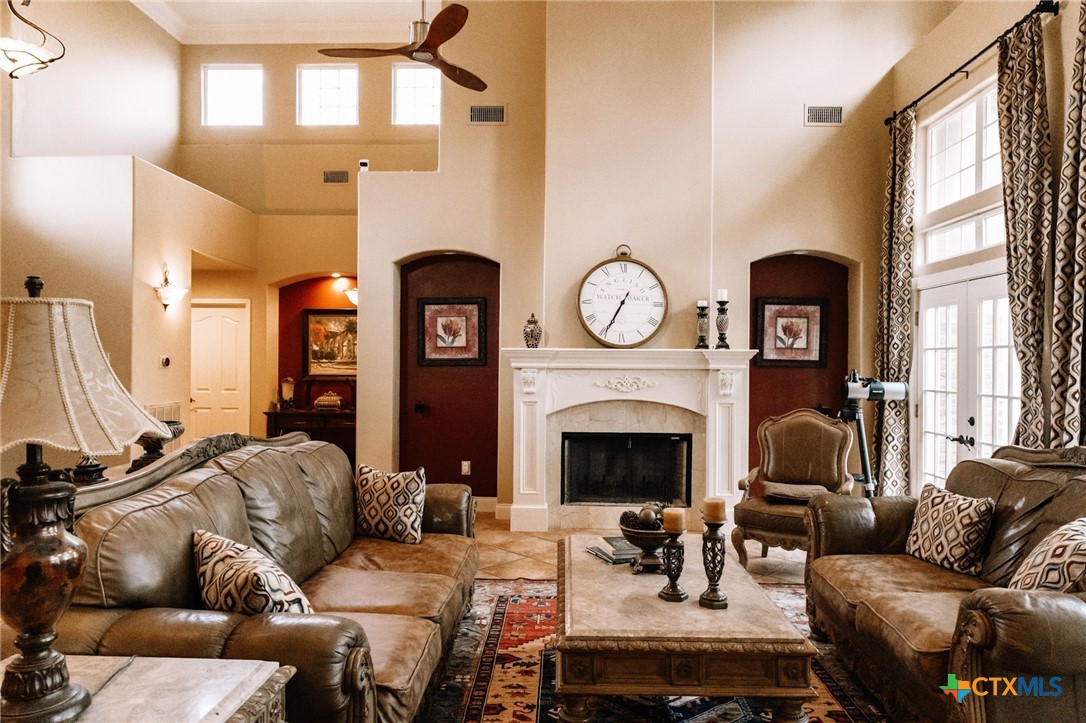 447 Schaefer Road Victoria, TX 77905 - Photo 9 of 25 a living room with furniture a fireplace and a large mirror