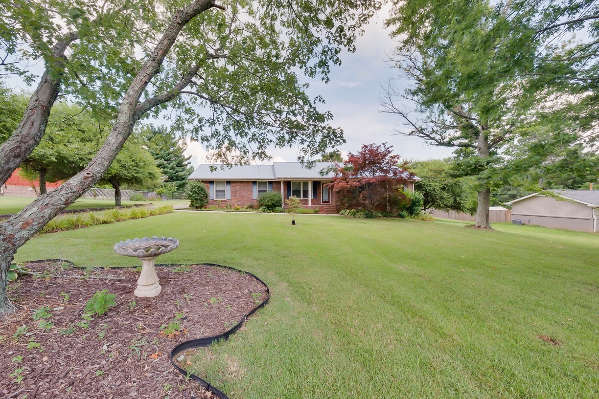 116 Green Acres Road Cottontown, TN 37048 - Photo 1 of 44 a view of a house with backyard and sitting area