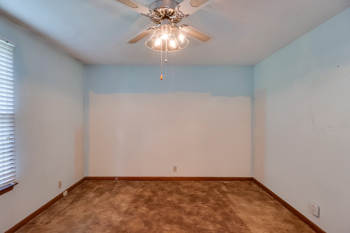 116 Green Acres Road Cottontown, TN 37048 - Photo 13 of 44 an empty room with a chandelier fan