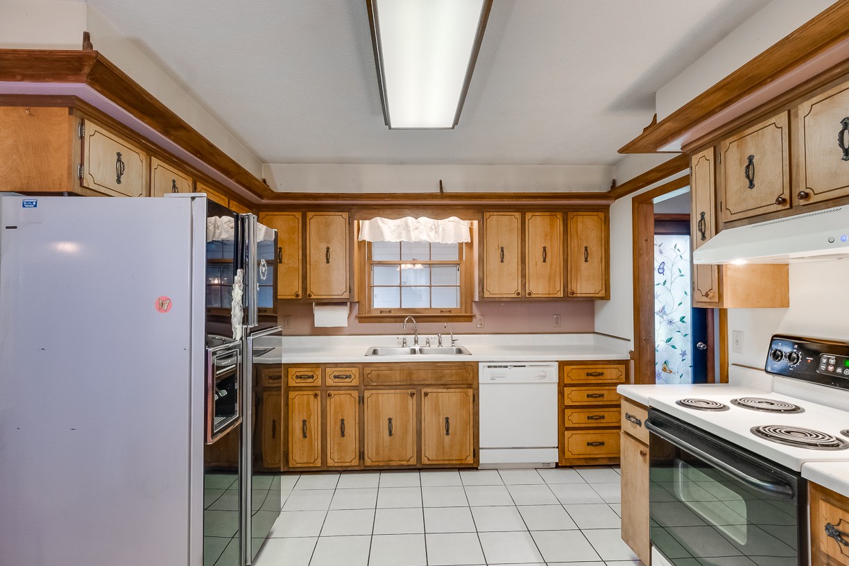 116 Green Acres Road Cottontown, TN 37048 - Photo 25 of 44 a kitchen with a stove top oven cabinets and a window