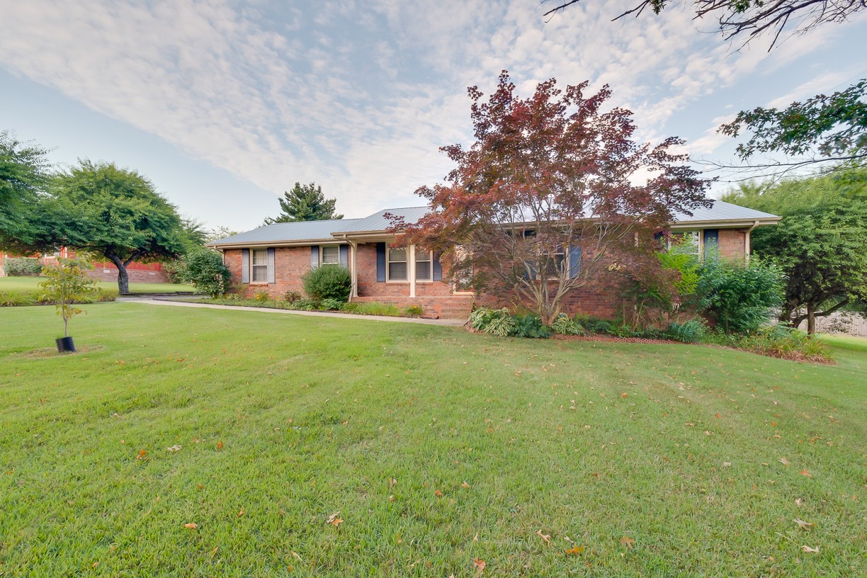 116 Green Acres Road Cottontown, TN 37048 - Photo 4 of 44 a front view of a house with garden