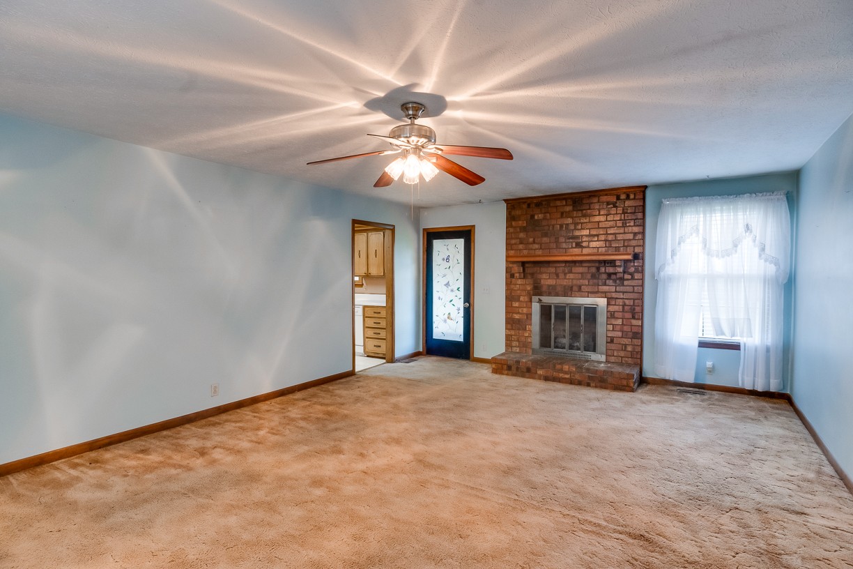 116 Green Acres Road Cottontown, TN 37048 - Photo 35 of 44 a view of a room with a ceiling fan and a fireplace