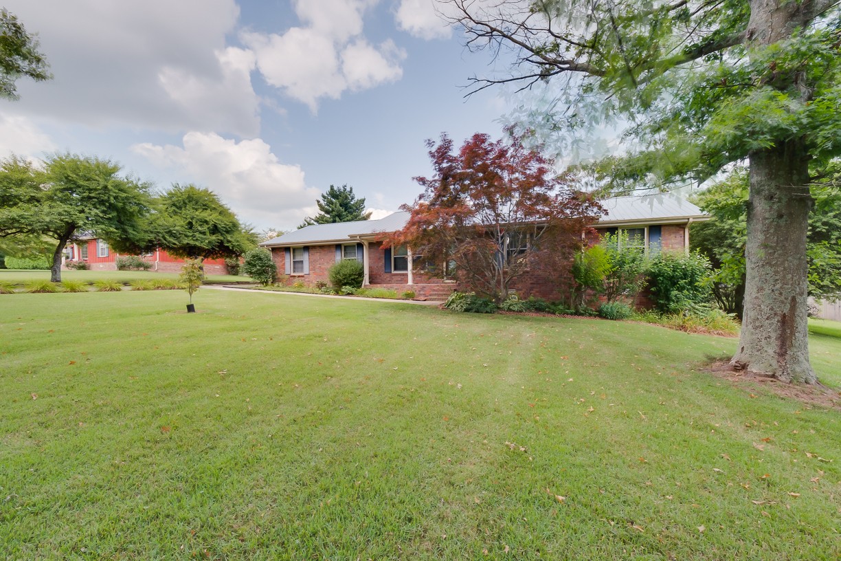 116 Green Acres Road Cottontown, TN 37048 - Photo 5 of 44 a front view of a house with garden