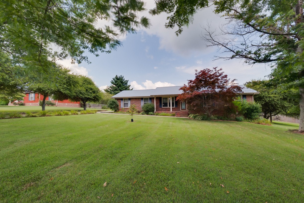 116 Green Acres Road Cottontown, TN 37048 - Photo 44 of 44 a front view of a house with a garden
