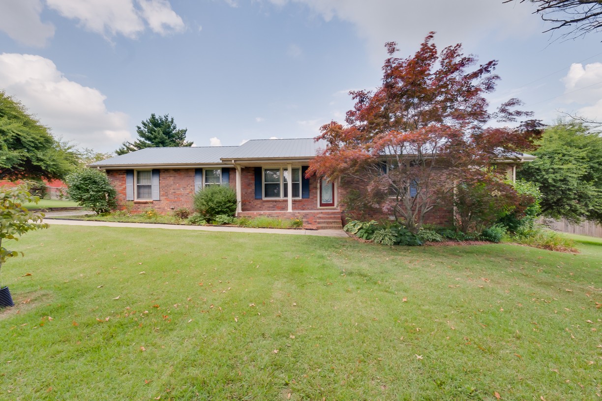 116 Green Acres Road Cottontown, TN 37048 - Photo 9 of 44 a front view of house with yard and green space