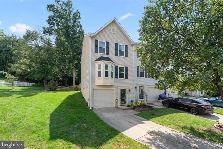 1163 Kelfield Drive, Unit 1163 Baltimore, MD 21227 - Photo 1 of 28 a front view of a house with a garden and yard