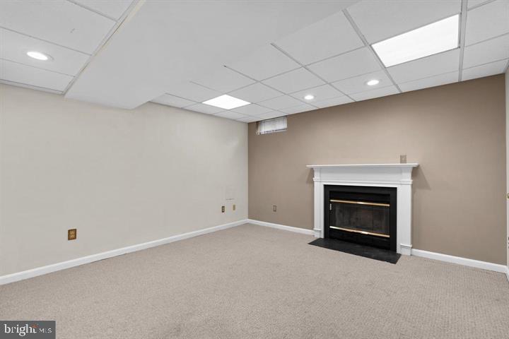 1163 Kelfield Drive, Unit 1163 Baltimore, MD 21227 - Photo 14 of 28 an empty room with a fireplace and window
