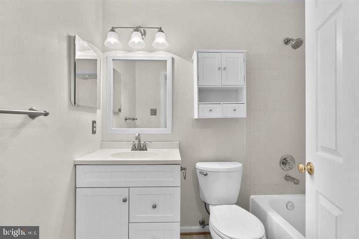 1163 Kelfield Drive, Unit 1163 Baltimore, MD 21227 - Photo 19 of 28 a bathroom with a toilet sink and mirror
