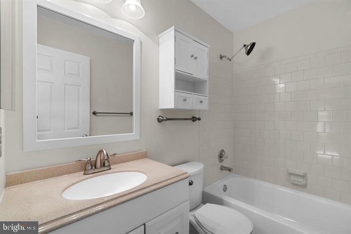 1163 Kelfield Drive, Unit 1163 Baltimore, MD 21227 - Photo 22 of 28 a bathroom with a granite countertop sink toilet and bathtub