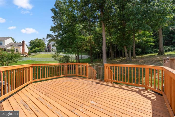 1163 Kelfield Drive, Unit 1163 Baltimore, MD 21227 - Photo 25 of 28 a balcony with wooden floor and fence