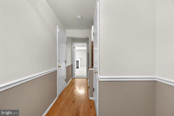 1163 Kelfield Drive, Unit 1163 Baltimore, MD 21227 - Photo 3 of 28 a view of a hallway with wooden floor