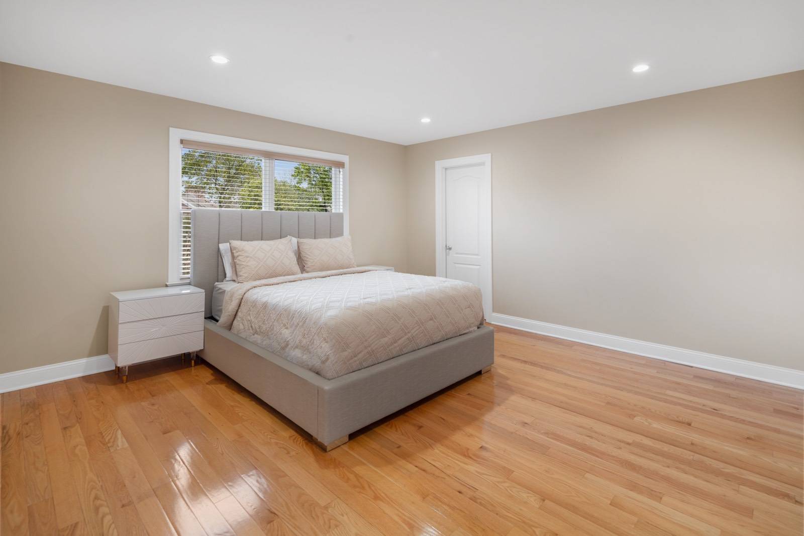 32 A Vail Avenue East Quogue, NY 11942 - Photo 15 of 24 a bedroom with a bed and a window