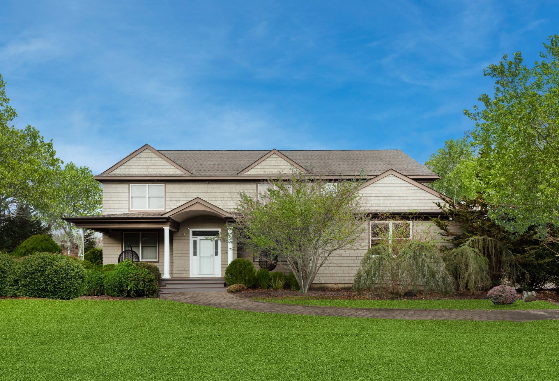 32 A Vail Avenue East Quogue, NY 11942 - Photo 24 of 24 a front view of a house with a garden and yard