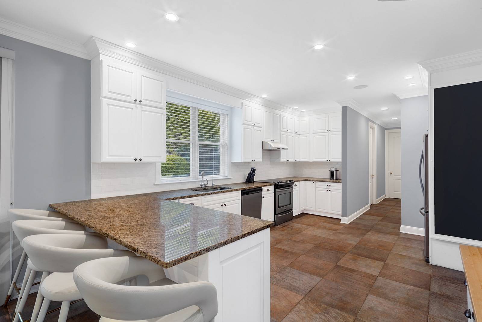 32 A Vail Avenue East Quogue, NY 11942 - Photo 7 of 24 a kitchen with granite countertop a sink and a refrigerator