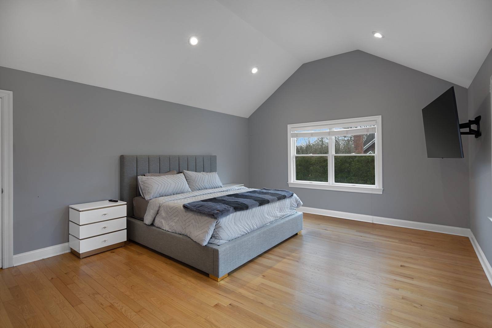 32 A Vail Avenue East Quogue, NY 11942 - Photo 9 of 24 a spacious bedroom with a bed and a large window