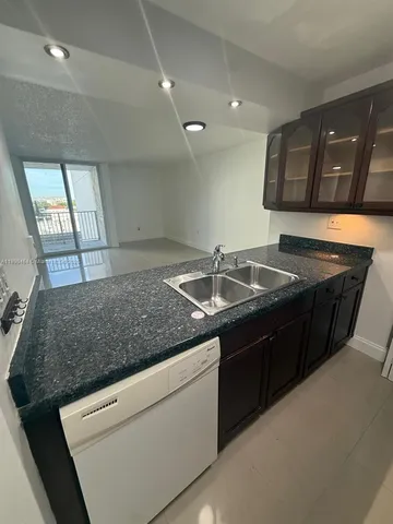 a kitchen with a sink and a refrigerator