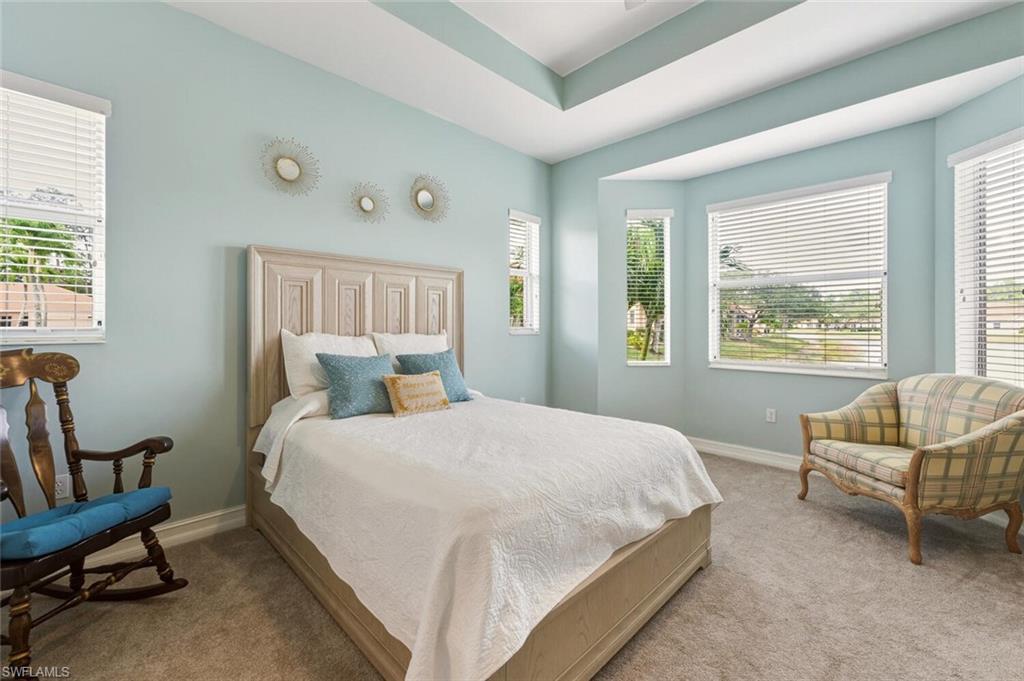 8063 Sanctuary Drive, Unit 1 Naples, FL 34104 - Photo 20 of 30 Bedroom with multiple windows and carpet floors