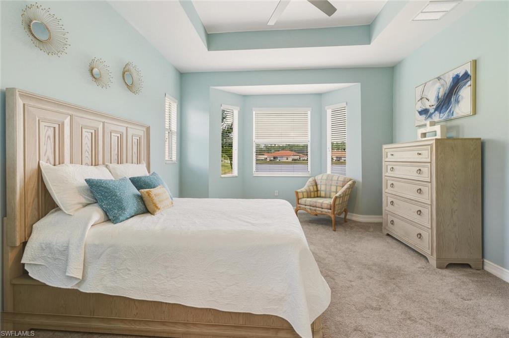 8063 Sanctuary Drive, Unit 1 Naples, FL 34104 - Photo 21 of 30 Bedroom featuring light colored carpet and ceiling fan