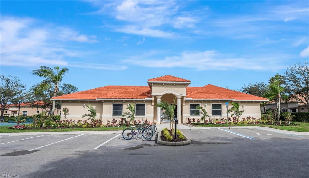 8063 Sanctuary Drive, Unit 1 Naples, FL 34104 - Photo 28 of 30 View of building exterior featuring uncovered parking