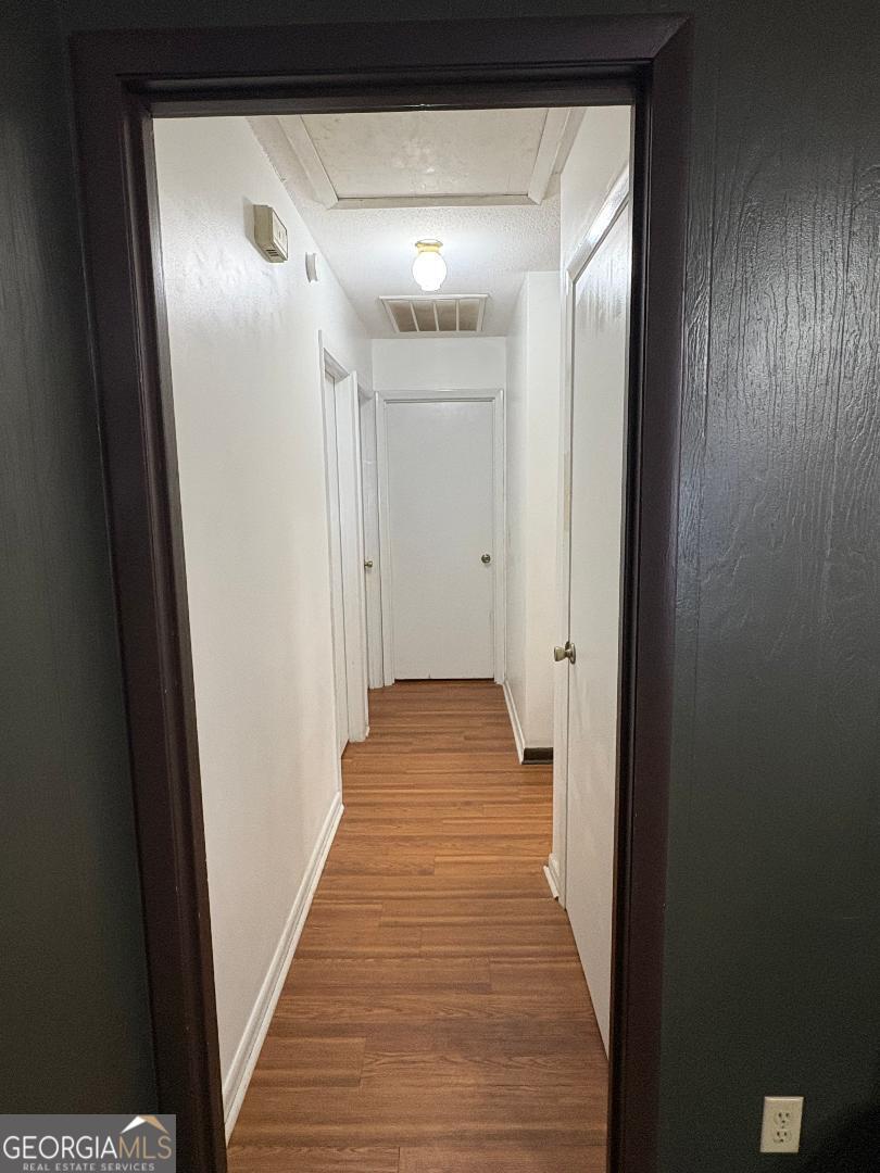 2103 Aimwell Road Vidalia, GA 30474 - Photo 13 of 22 a view of a hallway with wooden floor