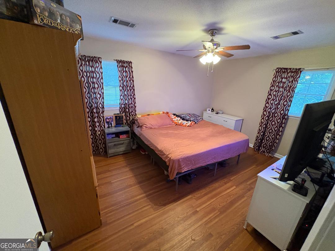 2103 Aimwell Road Vidalia, GA 30474 - Photo 15 of 22 a bed room with a bed window and a chair